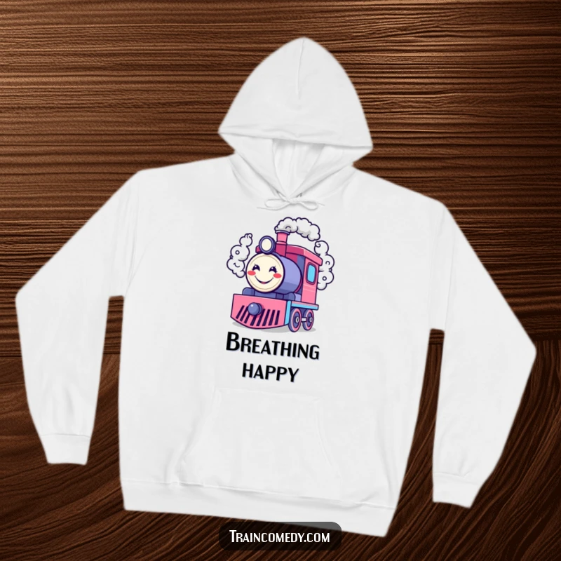 Funny hoodie with a happy train engine character blowing smoke rings shaped like cheerful smiley faces, combining comfort and contagious humor.