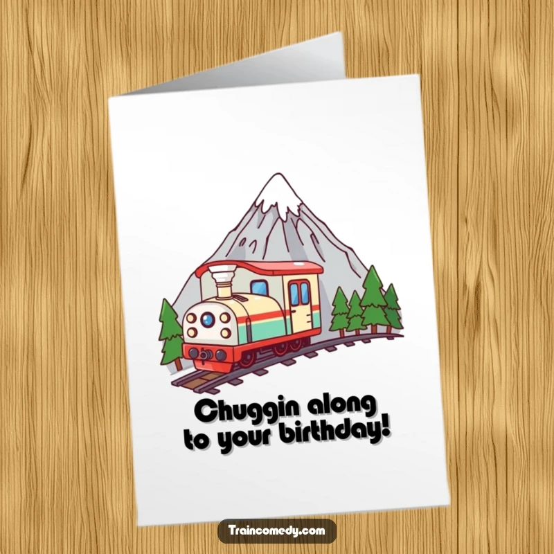 Funny Free Printable Birthday Card featuring a curious kawaii train peeking from behind a mountain illustration.